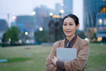 Professional Businesswoman in Urban Setting Embracing Evening Ambiance