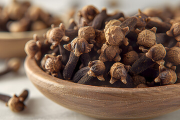 Obraz premium Whole Dried Cloves in a Bowl– Aromatic Spice for Culinary and Medicinal Use for Food Blogs, Recipes, Spice Packaging, E-commerce, Cookbooks, Ads, Social Media, Health Websites