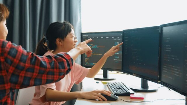 Slow motion back end software developer engineer for computer programming working together on debugging writing computing code, solving complex algorithms display on monitor in office. Burgeoning