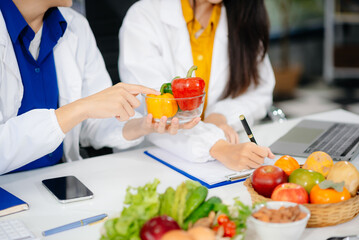 Doctors sharing fresh vegetables, promoting health and nutrition. Ideal for wellness, healthcare, and science themes.