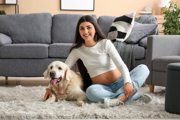 Beautiful pregnant woman with dog at home