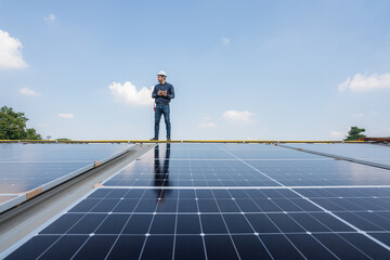 Engineer service check installation solar cell on the roof of factory. Silhouette technician...
