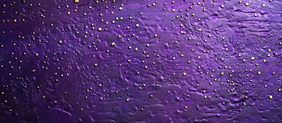 Purple textured background with small golden dots ideal for artistic designs and creative projects.