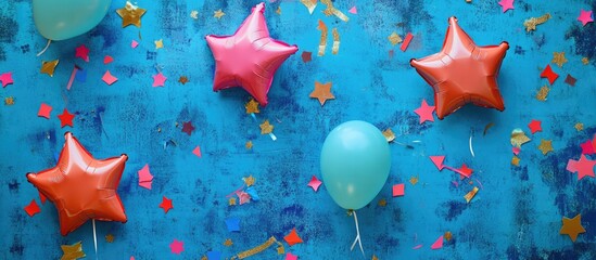 Celebration decor flat lay with colorful star balloons confetti and a vibrant blue background ideal for party invitations or promotional materials