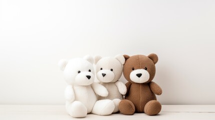 Adorable teddy bear toys in white and brown colors arranged together against a neutral background for a cozy and playful atmosphere.