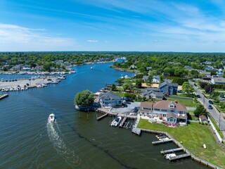 Aerial view of a coastal town with boats and greenery.