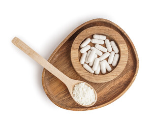 Wooden spoon with collagen powder and bowl of pills on white background