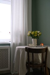 A Cozy Interior Featuring Beautiful Flowers and Soft Candles in Warm, Inviting Tones