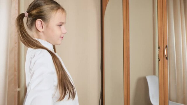Little girl getting dressed school uniform in her room and preparing go to school