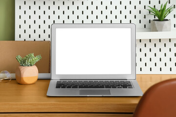 Fototapeta premium Stylish workplace with blank laptop, closeup. Freelance concept