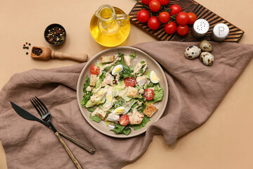 Plate with tasty chicken Caesar salad and ingredients on brown background