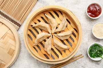 Bamboo steamer with tasty Japanese gyoza on white background