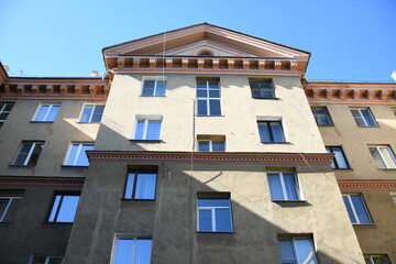 Architecture of old Soviet Union houses in Stalin's Empire style. Exterior of the facade of a vintage residential building in Russia