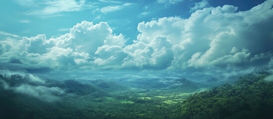 Fototapeta premium Lush green landscape with rolling hills and vibrant clouds under a bright blue sky capturing serene natural beauty and tranquility.