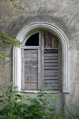 Closed window of an abandoned house.