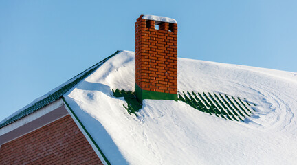 A chimney on a roof covered in snow