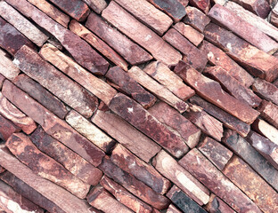 A brick wall with a red and brown color