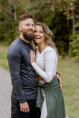 Happy couple, smiling, dancing, leading an active sporty lifestyle. Laughing and enjoying each other's company. Handsome bearded man and blonde woman
