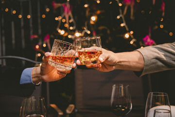 A group of friends enjoy an outdoor evening, drinking wine in a friendly and lively atmosphere. They celebrate togetherness, happiness and bonding.