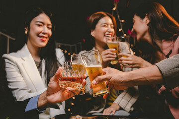 A cheerful group of friends enjoying wine and food on a sunny patio. Toasting with wineglasses, they celebrate togetherness in a scenic outdoor setting, blending fun, friendship, and a festive mood.