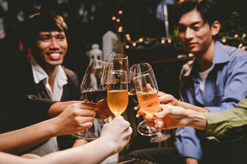 A cheerful group of friends enjoying wine and food on a sunny patio. Toasting with wineglasses, they celebrate togetherness in a scenic outdoor setting, blending fun, friendship, and a festive mood.