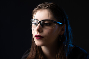Fototapeta premium Gothic stylish portrait of a girl in the studio in a neon glow.