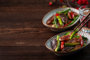 Delicious spicy homemade stir-fried Chinese smoked sausage with asparagus.