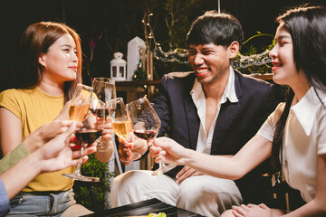 A joyful group of friends and family gathered around a dinner table, raising wine glasses in a celebratory toast. Smiling and laughing, they enjoy food, drinks, and togetherness in a festive atmospher