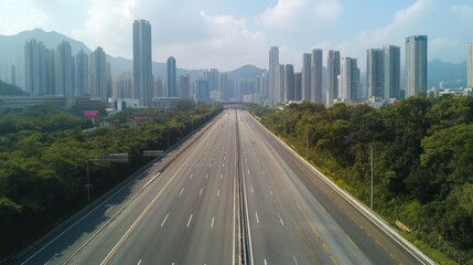 Fototapeta premium Empty Highway Leading to a City Skyline under a Sunny Sky