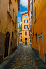 Fototapeta premium Brescia, Italy. Traditional colorful building with balconies, shutter windows and multicolored walls in typical italian street