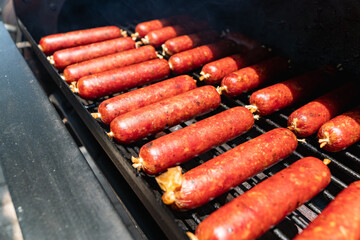 smoked sausages with red mahogany color in a collagen casing, in an offset smoker, closed up