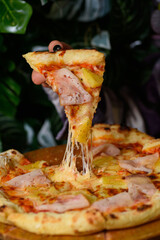 pizza with meat, cheese and pineapples