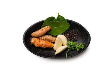 A variety of spices in a wooden bowl, isolated on white background