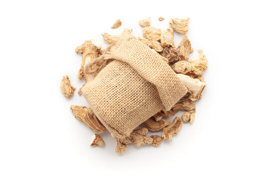 Close-up of organic Ginger Root (Zingiber officinale) or sonth in a jute bag on a heap of sonth, isolated on a white background.