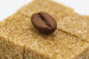 beautiful picture, background with coffee beans and sugar, coffee grain lying on cubes of cane sugarbeautiful picture, background with coffee beans and sugar, coffee grain lying on cubes of cane sugar