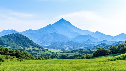 Fototapeta premium Panoramic view of a majestic mountain range on a sunny day, with a vast green field in the foreground.