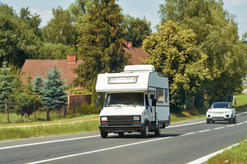 RV traveling scenic route by green countryside