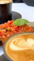 Bruschetta showcasing Mediterranean produce paired with coffee reflects seasonal eco-conscious farming practices and the region's culinary simplicity. Natural bruschetta coffee pairing.