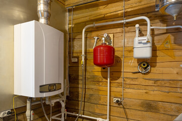Gas boiler, expansion tank, heating pipe layout in a private house. Home heating and water supply system..