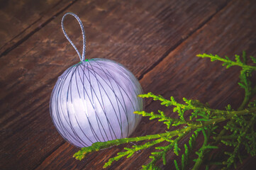 Colored balls and fir branches on a wooden background. New Year Christmas background