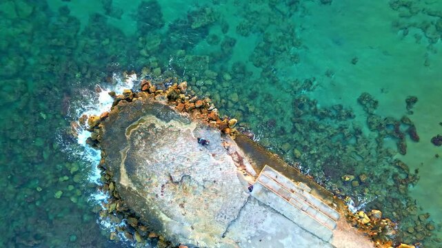 Aerial view of rocky shoreline at &Alpha;&nu;ά&lambda;&eta;&psi;&eta;, peaceful sea, Chersonisos, Greece
