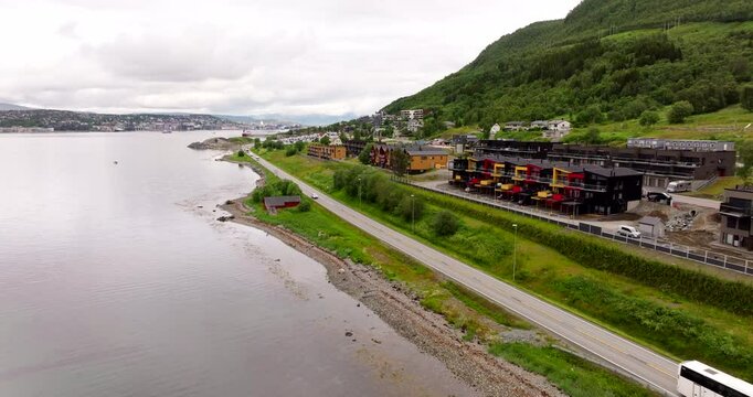E8 road along fjord, Tromso in summer season, Norwegian landscape, Northern Norway in Scandinavia. Aerial backward