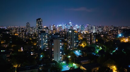 Fototapeta premium Nighttime Cityscape Overlooking Towers and Buildings Illuminated with Lights in Urban Landscape, Highlights of Life and Activity in a Metropolitan Area