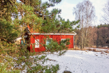 Idyllic old red croft in a forest in the winter © Lars Johansson