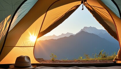 A person is sitting in a tent with a hat on and a view of mountains