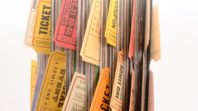 Old tickets stuck between the pages of a rolled-up magazine, close up view