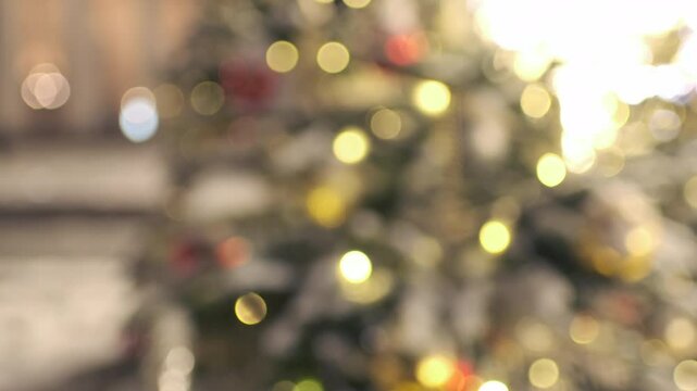 defocused Merry Christmas Christmas happy holidays. Defocused decoration ornaments ball and defused garland lights on classic decorated Christmas tree. copy space