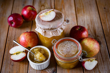 Apple jam in a glass jar for dessert. Homemade preparations for the winter. A jar of jam on a wooden table. Close-up