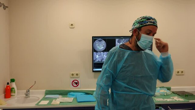 Dentist gestures he cannot hear his patient while wearing a face mask, slow motion