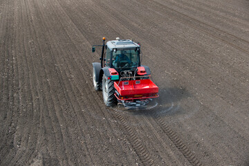 Tractor spreading artificial fertilizers